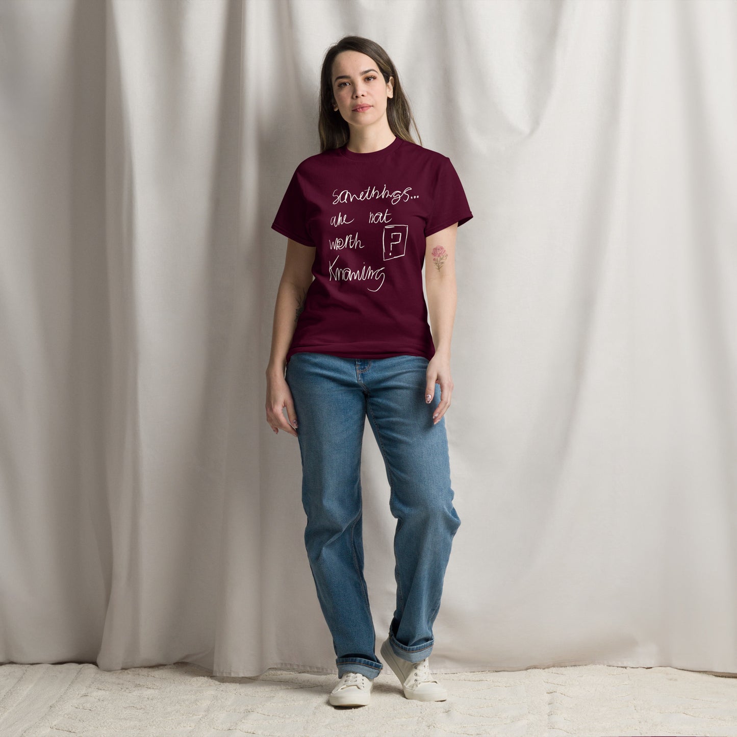 Minimalist black slogan t-shirt featuring the white text phrase 'Some things are not worth knowing' by London artist VKM Illustrations.