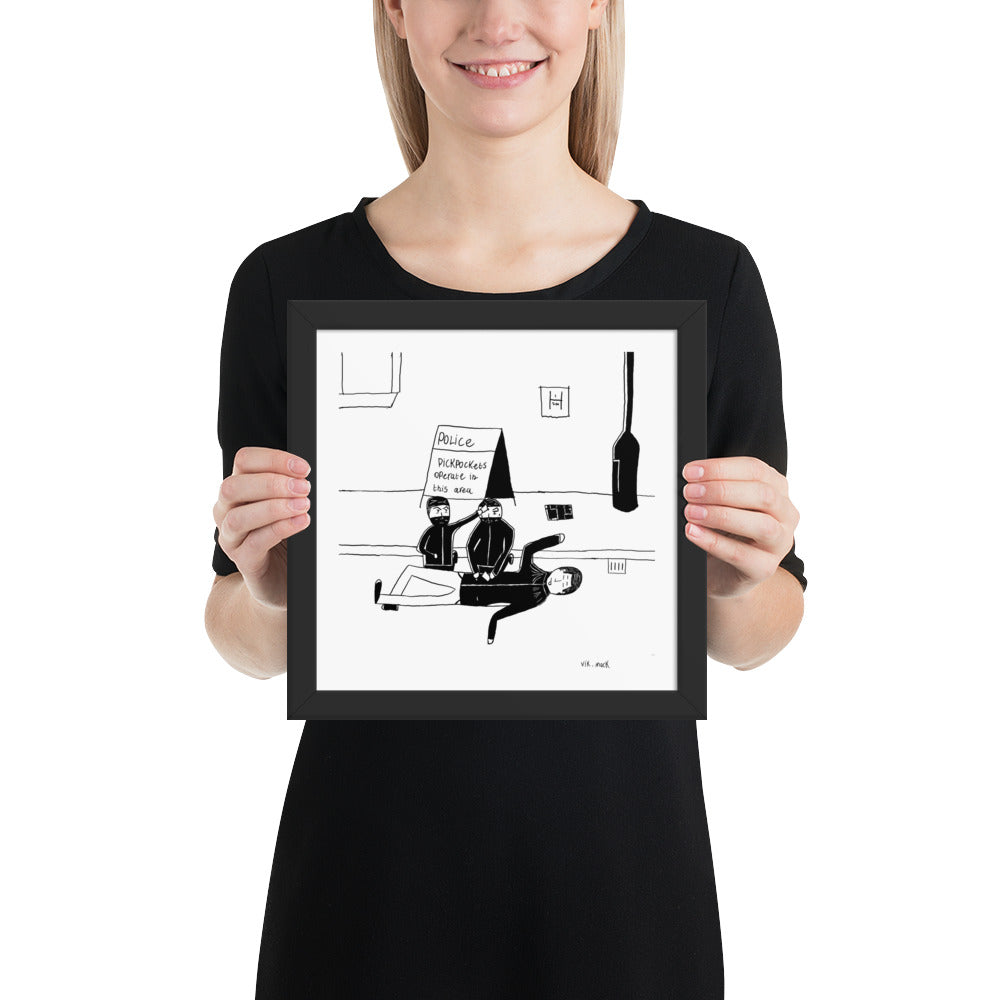 10x10 inch square matte black framed satirical print titled Pickpockets operate in this area featuring a newspaper style street art cartoon by London artist VKM Illustrations.