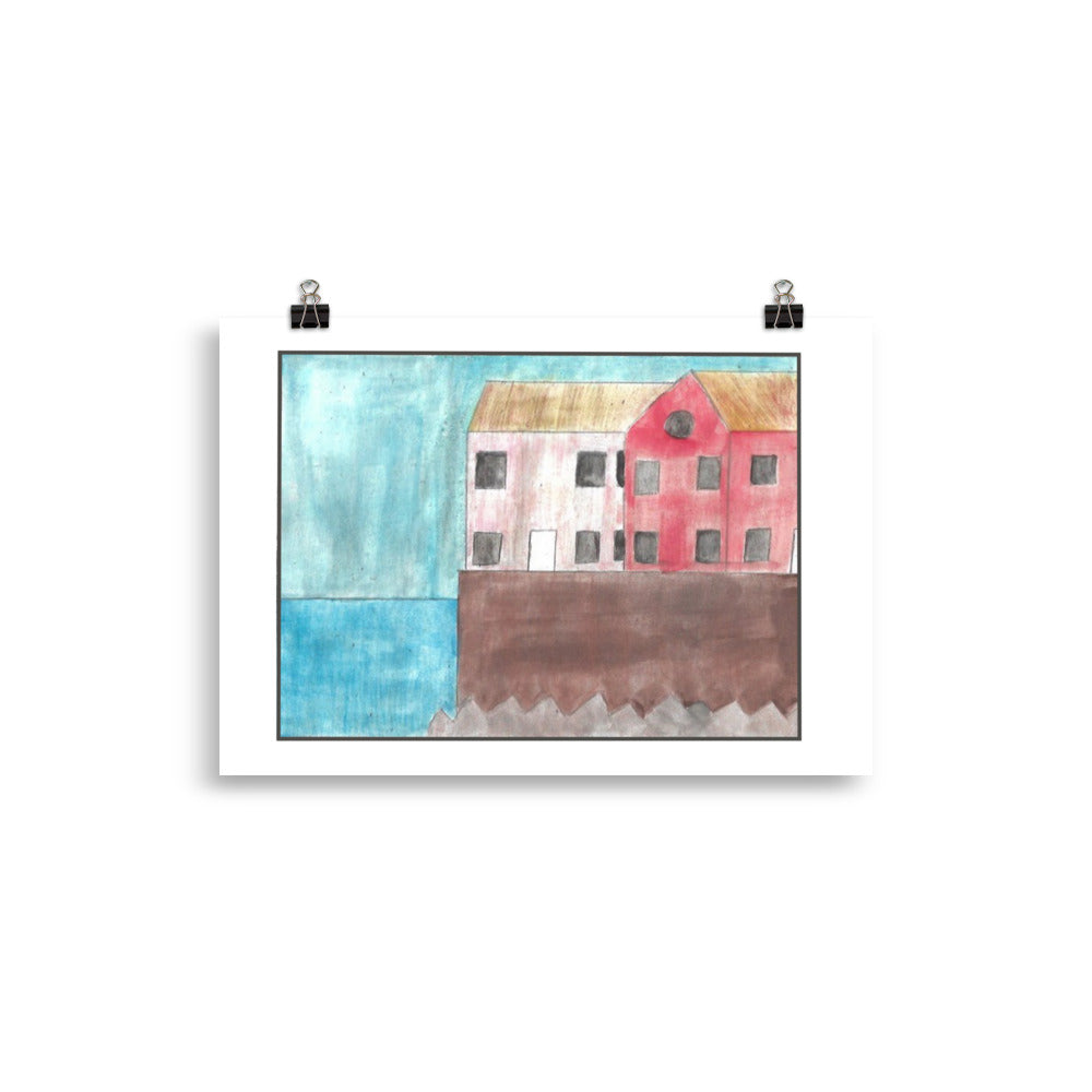"Museum-quality matte poster featuring 'Living by the Coast' watercolour illustration of pink and red seaside houses on a seawall from the Art of Isolation Exhibition by London artist VKM Illustrations."