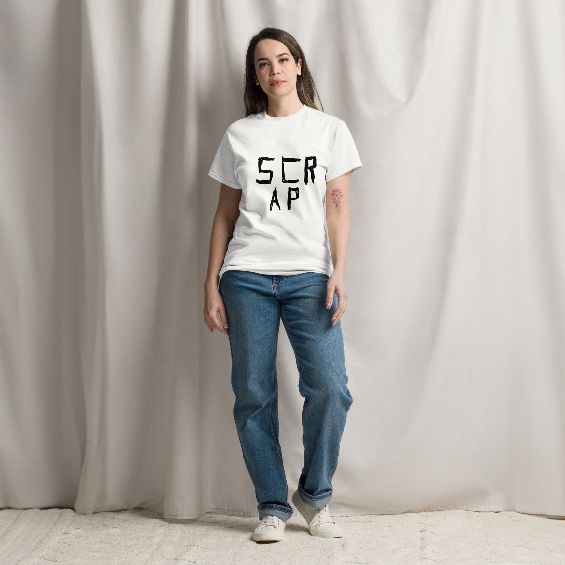 “Minimalist white graphic novel t-shirt featuring the black ink text phrase 'Scrap' by London comic artist VKM Illustration.”